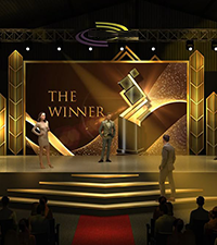 Award night stage with presenters and winner graphics displayed on a large backdrop
