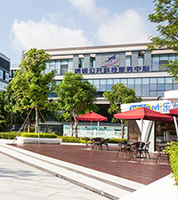 Modern business park exterior with landscaped walkways, seating, and outdoor space