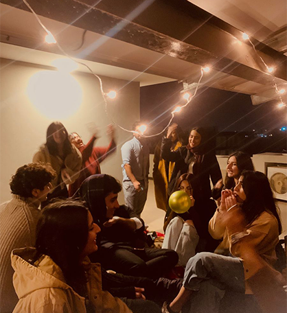 Photographer documenting friends enjoying a lively party celebration at an indoor venue