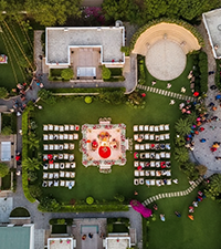 Aerial view of a private villa event setup with decorated seating and landscaped garden