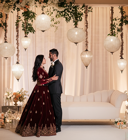 Couple posing together during an elegant reception photography session at a decorated hall