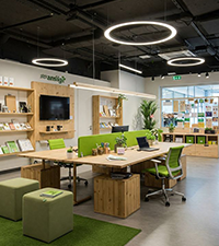 Modern startup office interior with workstations, seating, plants, and open spaces